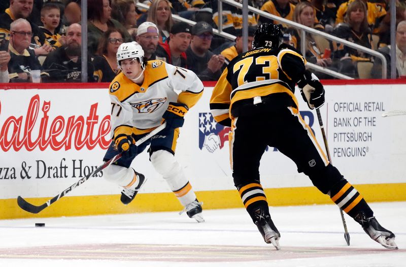 Apr 15, 2024; Pittsburgh, Pennsylvania, USA;  Nashville Predators right wing Luke Evangelista (77) skates up ice with the puck as defenseman Pierre-Olivier Joseph (73) defends during the second period at PPG Paints Arena. Mandatory Credit: Charles LeClaire-USA TODAY Sports