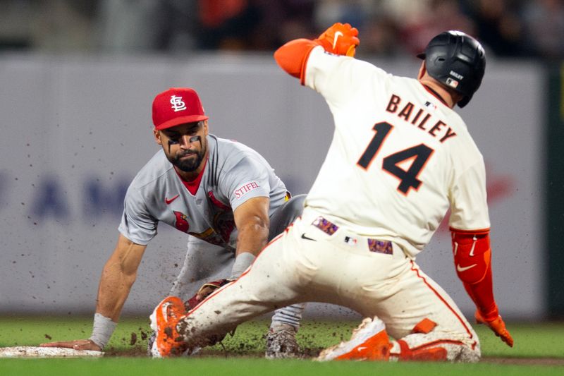 Sep 22, 2025; San Francisco, California, USA; St. Louis Cardinals second baseman José Fermín (left) tags out San Francisco Giants catcher Patrick Bailey (14) as he tries to stretch a single into a double during the sixth inning at Oracle Park. Mandatory Credit: D. Ross Cameron-Imagn Images