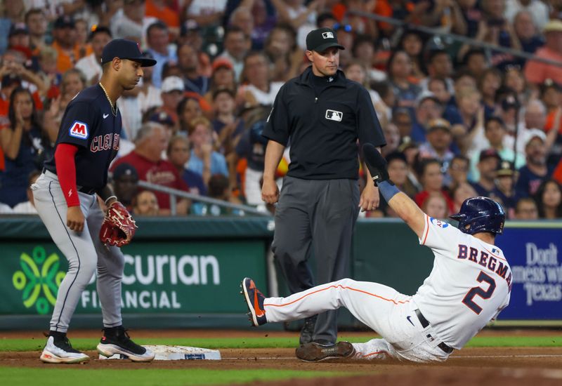 Aug 2, 2023; Houston, Texas, USA; Houston Astros third baseman Alex Bregman (2) slides into third base safely as Cleveland Guardians third baseman Brayan Rocchio (6) awaits the throw in the seventh inning at Minute Maid Park. Mandatory Credit: Thomas Shea-USA TODAY Sports