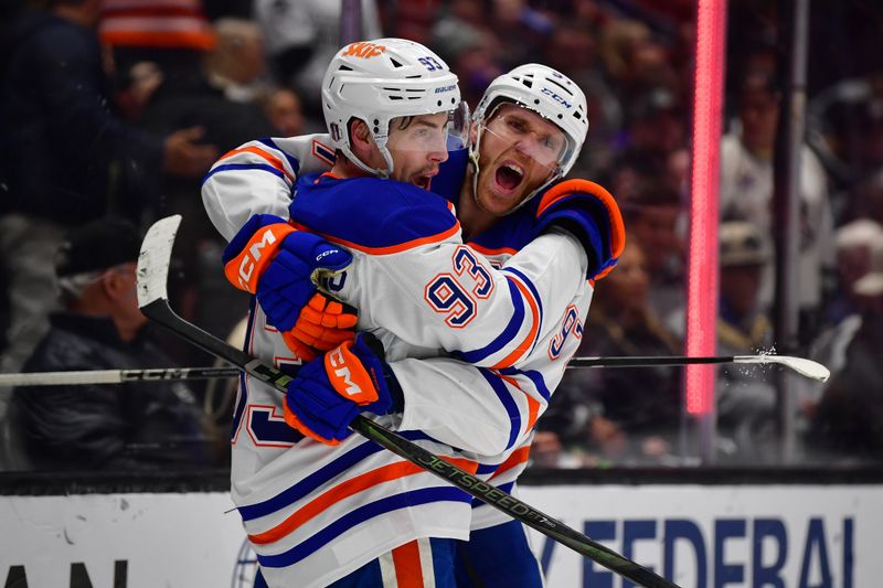 Apr 29, 2025; Los Angeles, California, USA; Edmonton Oilers center Ryan Nugent-Hopkins (93) celebrates his empty net goal scored against the Los Angeles Kings with center Connor McDavid (97) during the third period in game five of the first round of the 2025 Stanley Cup Playoffs at Crypto.com Arena. Mandatory Credit: Gary A. Vasquez-Imagn Images
