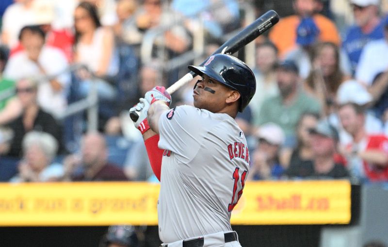 Jun 17, 2024; Toronto, Ontario, CAN;  Boston Red Sox third baseman Rafael Devers (11) hits a solo home run against the Toronto Blue Jays in the first inning at Rogers Centre. Mandatory Credit: Dan Hamilton-USA TODAY Sports