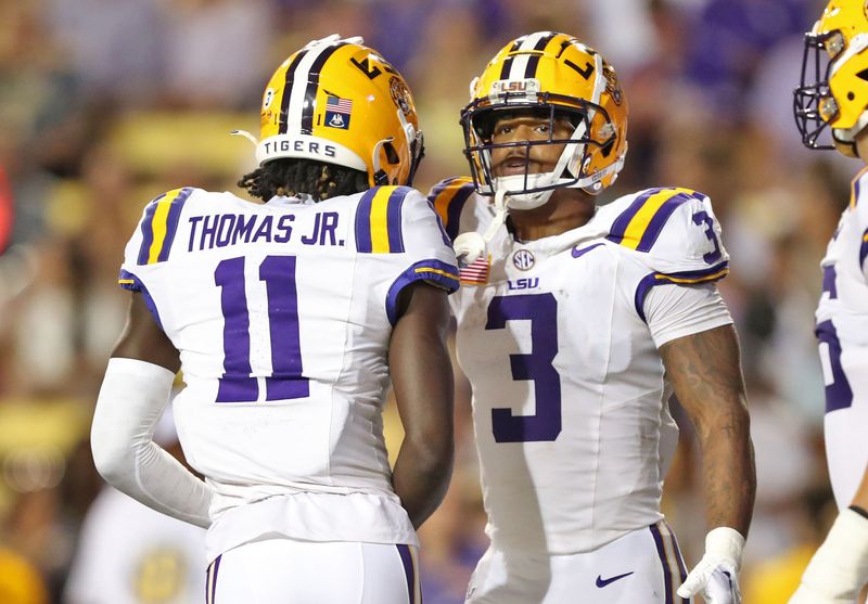 Oct 21, 2023; Baton Rouge, Louisiana, USA; LSU Tigers running back Logan Diggs (3) celebrates a touchdown with wide receiver Brian Thomas Jr. (11) during the first half against the Army Black Knights at Tiger Stadium. Mandatory Credit: Danny Wild-USA TODAY Sports