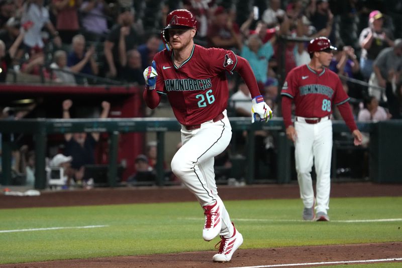 Aug 20, 2025; Phoenix, Arizona, USA; Arizona Diamondbacks first base Pavin Smith (26) scores a run against the Cleveland Guardians in the tenth inning at Chase Field. Mandatory Credit: Rick Scuteri-Imagn Images