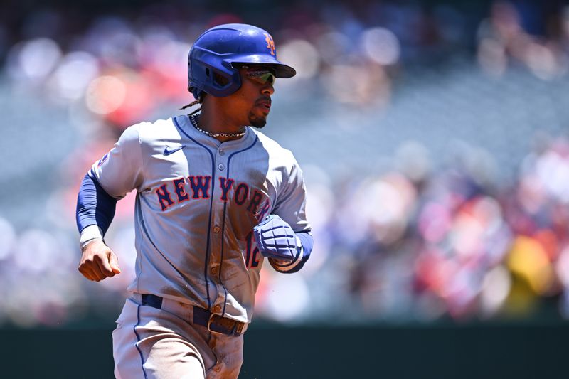 Aug 4, 2024; Anaheim, California, USA; New York Mets shortstop Francisco Lindor (12) steals second and third base against the Los Angeles Angels during the first inning at Angel Stadium. Mandatory Credit: Jonathan Hui-USA TODAY Sports