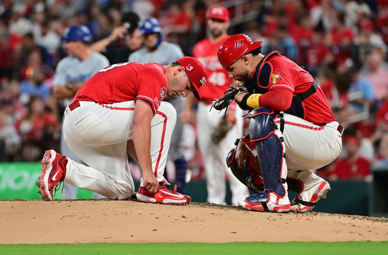 Aug 17, 2024; St. Louis, Missouri, USA; St. Louis Cardinals catcher Willson Contreras (40, right) visits the mound to talk with St. Louis Cardinals pitcher Andre Pallante (53) as he ties his shoelace in the sixth inning at Busch Stadium in a game against the Los Angeles Dodgers. Mandatory Credit: Tim Vizer-USA TODAY Sports
