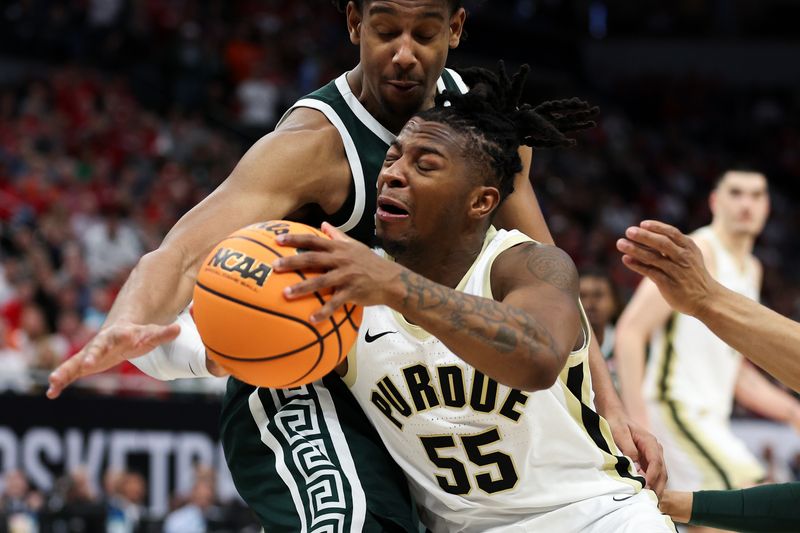 Mar 15, 2024; Minneapolis, MN, USA; Purdue Boilermakers guard Lance Jones (55) inbounds the ball as Michigan State Spartans guard A.J. Hoggard (11) defends during the second half at Target Center. Mandatory Credit: Matt Krohn-USA TODAY Sports