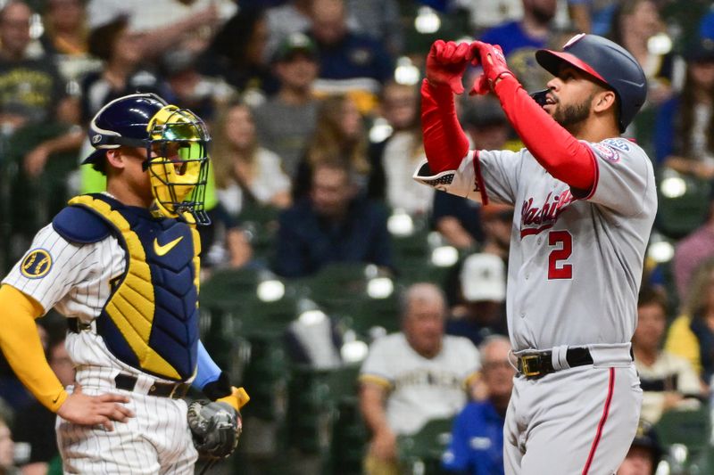 Sep 16, 2023; Milwaukee, Wisconsin, USA; Washington Nationals second baseman Luis Garcia (2) reacts after hitting a solo home run in the third inning as Milwaukee Brewers catcher William Contreras (24) looks on at American Family Field. Mandatory Credit: Benny Sieu-USA TODAY Sports