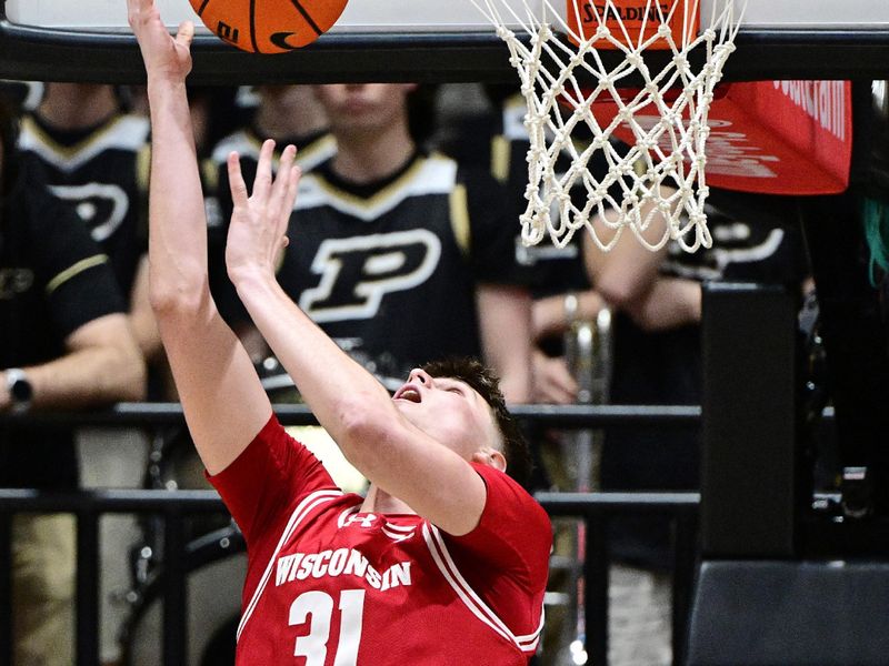 Feb 15, 2025; West Lafayette, Indiana, USA; Wisconsin Badgers forward Nolan Winter (31) shoots the ball backwards during the second half against the Purdue Boilermakers at Mackey Arena. Mandatory Credit: Marc Lebryk-Imagn Images