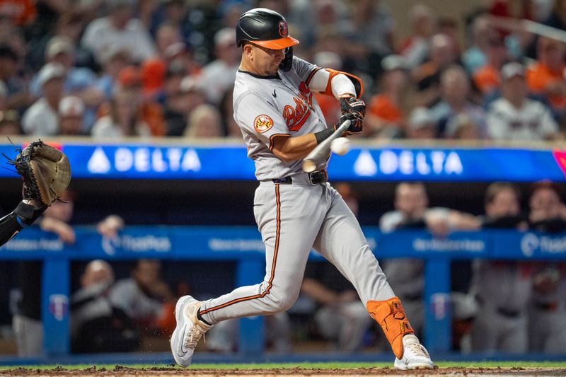 Sep 27, 2024; Minneapolis, Minnesota, USA; Baltimore Orioles third baseman Ramon Urias (29) hits a sacrifice fly in the second inning at Target Field. Mandatory Credit: Matt Blewett-Imagn Images