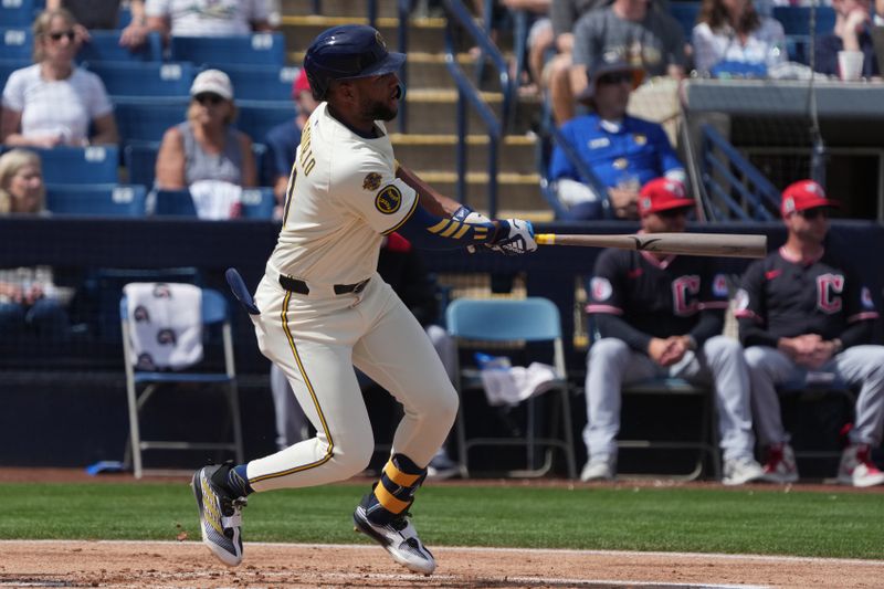 Mar 16, 2025; Phoenix, Arizona, USA; Milwaukee Brewers outfielder Jackson Chourio (11) hits against the Cleveland Guardians in the first inning at American Family Fields of Phoenix. Mandatory Credit: Rick Scuteri-Imagn Images