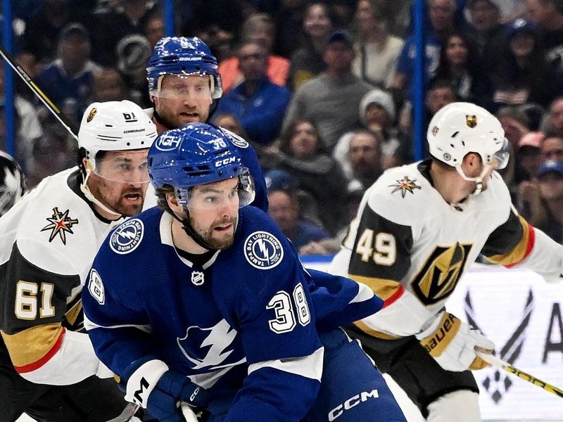 Dec 21, 2023; Tampa, Florida, USA; Tampa Bay Lightning left wing Brandon Hagel (38) pushes the puck up the ice in the first period against the Las Vegas Golden Knights at Amalie Arena. Mandatory Credit: Jonathan Dyer-USA TODAY Sports