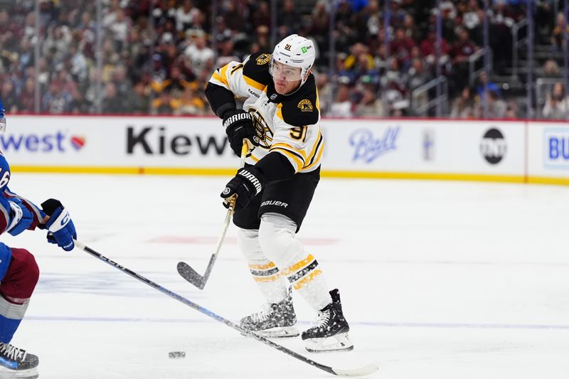 Oct 16, 2024; Denver, Colorado, USA; Boston Bruins defenseman Nikita Zadorov (91) shoots the puck in the first period against the Colorado Avalanche at Ball Arena. Mandatory Credit: Ron Chenoy-Imagn Images