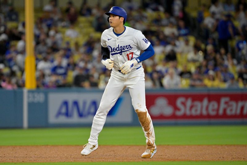 Aug 23, 2024; Los Angeles, California, USA;  Los Angeles Dodgers designated hitter Shohei Ohtani (17) takes a lead off second after his 40th stolen base the fourth inning at Dodger Stadium. Mandatory Credit: Jayne Kamin-Oncea-USA TODAY Sports