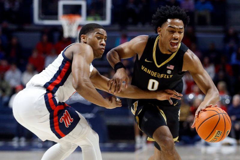 Jan 13, 2024; Oxford, Mississippi, USA; Vanderbilt Commodores guard Tyrin Lawrence (0) drives to the basket as Mississippi Rebels guard Matthew Murrell (11) defends during the first half at The Sandy and John Black Pavilion at Ole Miss. Mandatory Credit: Petre Thomas-USA TODAY Sports