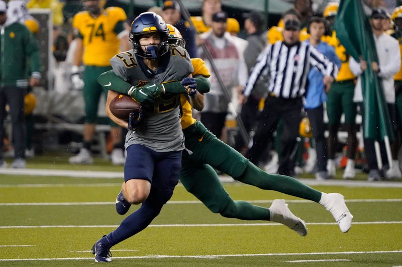 Nov 25, 2023; Waco, Texas, USA; West Virginia Mountaineers wide receiver Preston Fox (29) is tackled by Baylor Bears cornerback Caden Jenkins (19) during the first half at McLane Stadium. Mandatory Credit: Raymond Carlin III-USA TODAY Sports