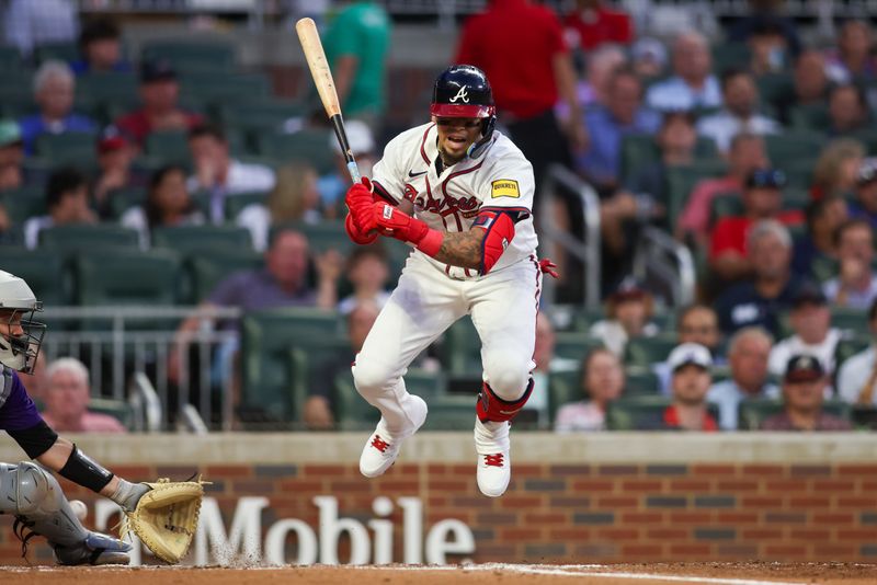 Sep 3, 2024; Atlanta, Georgia, USA; Atlanta Braves shortstop Orlando Arcia (11) gets out of the way of a pitch against the Colorado Rockies in the third inning at Truist Park. Mandatory Credit: Brett Davis-Imagn Images 
