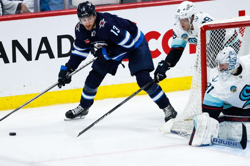 Apr 16, 2024; Winnipeg, Manitoba, CAN;  Winnipeg Jets forward Gabriel Vilardi (13) skates away from Seattle Kraken defenseman Ryker Evans (39) during the third period at Canada Life Centre. Mandatory Credit: Terrence Lee-USA TODAY Sports