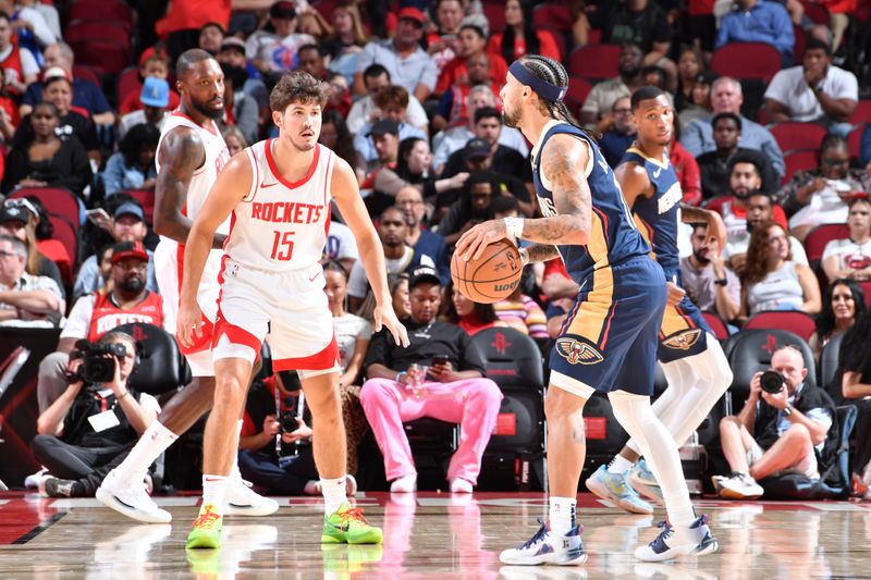 HOUSTON, TX - OCTOBER 15: Reed Sheppard #15 of the Houston Rockets plays defense during the game against the New Orleans Pelicans during a NBA preseason game on October 15, 2024 at the Toyota Center in Houston, Texas. NOTE TO USER: User expressly acknowledges and agrees that, by downloading and or using this photograph, User is consenting to the terms and conditions of the Getty Images License Agreement. Mandatory Copyright Notice: Copyright 2024 NBAE (Photo by Logan Riely/NBAE via Getty Images)