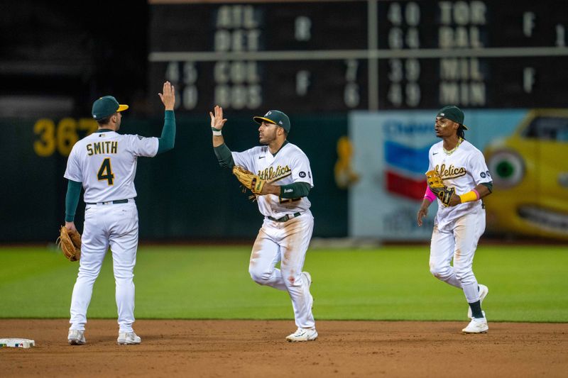 Jun 13, 2023; Oakland, California, USA; Oakland Athletics right fielder Ramon Laureano (22) high fives shortstop Kevin Smith (4) after the game against the Tampa Bay Rays at Oakland-Alameda County Coliseum. Mandatory Credit: Neville E. Guard-USA TODAY Sports