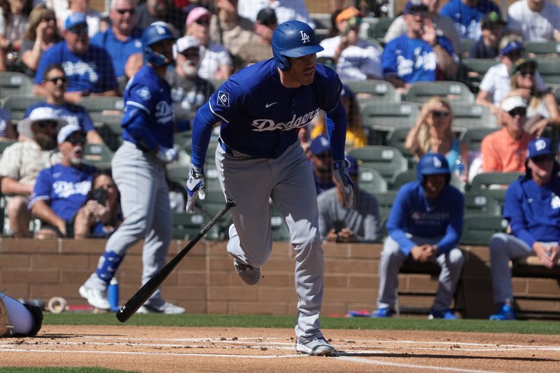 Feb 27, 2025; Salt River Pima-Maricopa, Arizona, USA; Los Angeles Dodgers first base Freddie Freeman (5) hits a single against the Colorado Rockies during the first inning at Salt River Fields at Talking Stick. Mandatory Credit: Rick Scuteri-Imagn Images