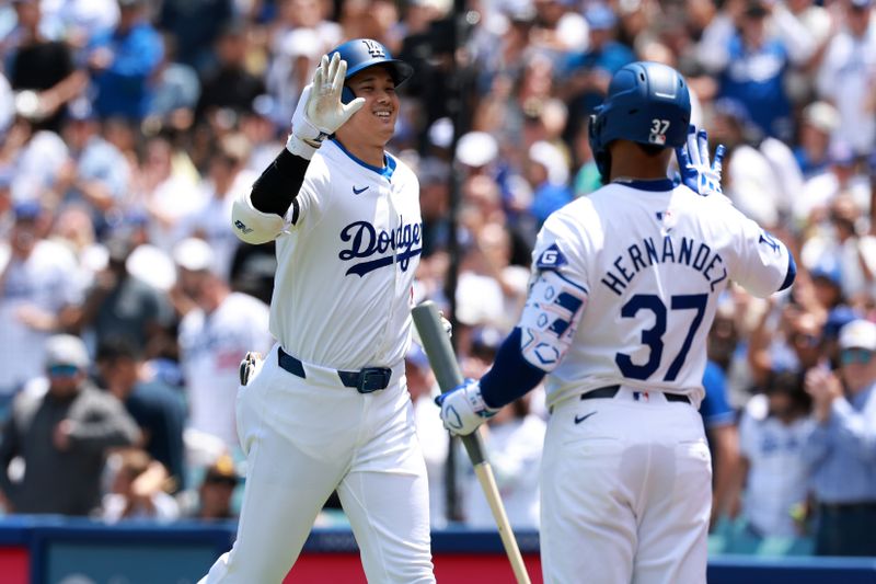 May 5, 2024; Los Angeles, California, USA;  Los Angeles Dodgers designated hitter Shohei Ohtani (17) is greeted by outfielder Teoscar Hernandez (37) after hitting a home run during the first inning against the Atlanta Braves at Dodger Stadium. Mandatory Credit: Kiyoshi Mio-USA TODAY Sports