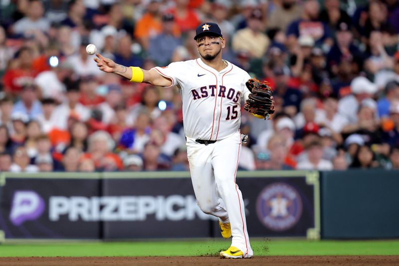 Jun 26, 2025; Houston, Texas, USA; Houston Astros third baseman Isaac Paredes (15) throws a fielded ball to first base for an out against the Philadelphia Phillies during the seventh inning at Daikin Park. Mandatory Credit: Erik Williams-Imagn Images