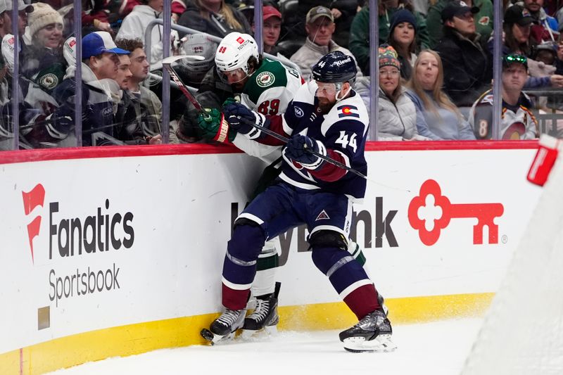 Jan 20, 2025; Denver, Colorado, USA; Colorado Avalanche defenseman Calvin de Haan (44) checks Minnesota Wild center Frederick Gaudreau (89) in the first period at Ball Arena. Mandatory Credit: Ron Chenoy-Imagn Images