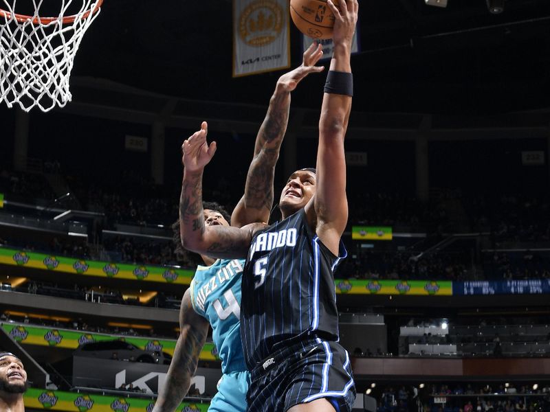 ORLANDO, FL - MARCH 19: Paolo Banchero #5 of the Orlando Magic drives to the basket during the game against the Charlotte Hornets on March 19, 2024 at the Kia Center in Orlando, Florida. NOTE TO USER: User expressly acknowledges and agrees that, by downloading and or using this photograph, User is consenting to the terms and conditions of the Getty Images License Agreement. Mandatory Copyright Notice: Copyright 2024 NBAE (Photo by Fernando Medina/NBAE via Getty Images)