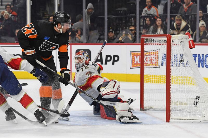 Jan 13, 2025; Philadelphia, Pennsylvania, USA; Philadelphia Flyers left wing Noah Cates (27) scores a goal past Florida Panthers center Eetu Luostarinen (27) during the third period at Wells Fargo Center. Mandatory Credit: Eric Hartline-Imagn Images