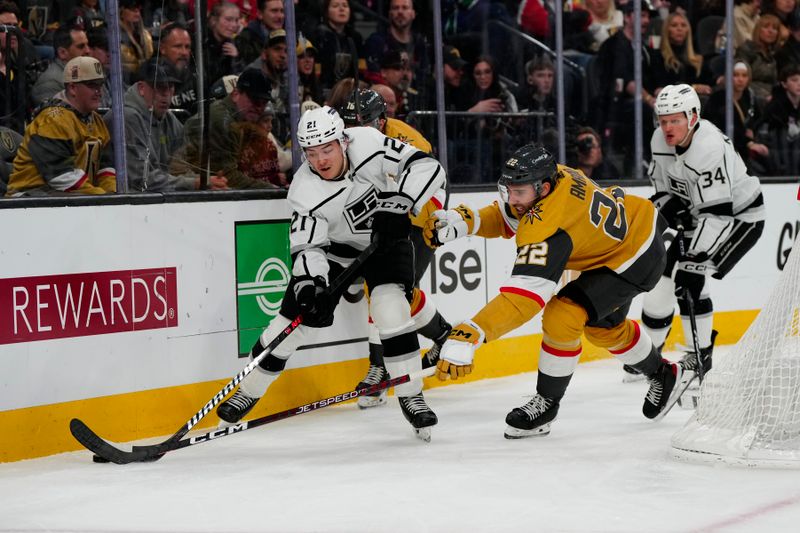 Dec 28, 2023; Las Vegas, Nevada, USA; Los Angeles Kings defenseman Jordan Spence (21) skates with the puck against Vegas Golden Knights right wing Michael Amadio (22) during the second period at T-Mobile Arena. Mandatory Credit: Lucas Peltier-USA TODAY Sports