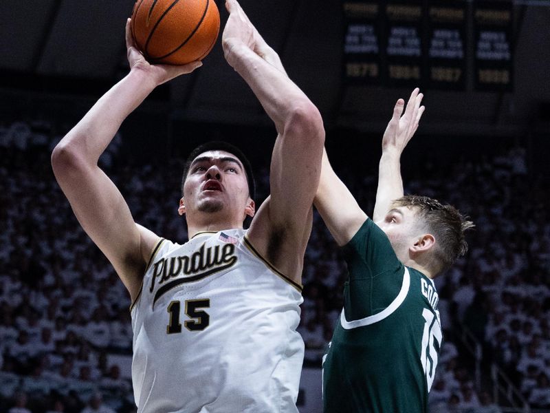 Jan 29, 2023; West Lafayette, Indiana, USA;  Purdue Boilermakers center Zach Edey (15) shoots the ball while Michigan State Spartans center Carson Cooper (15) defends in the second half at Mackey Arena. Mandatory Credit: Trevor Ruszkowski-USA TODAY Sports