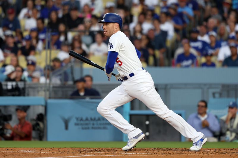 Jul 2, 2024; Los Angeles, California, USA;  Los Angeles Dodgers first baseman Freddie Freeman (5) hits an RBI single during the third inning against the Arizona Diamondbacks at Dodger Stadium. Mandatory Credit: Kiyoshi Mio-USA TODAY Sports