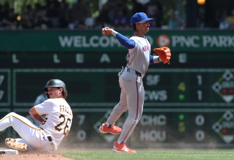 Jun 29, 2025; Pittsburgh, Pennsylvania, USA;  /New York Mets shortstop Francisco Lindor (12) turns a double play over Pittsburgh Pirates second baseman Adam Frazier (26) to end the sixth inning at PNC Park. Mandatory Credit: Charles LeClaire-Imagn Images