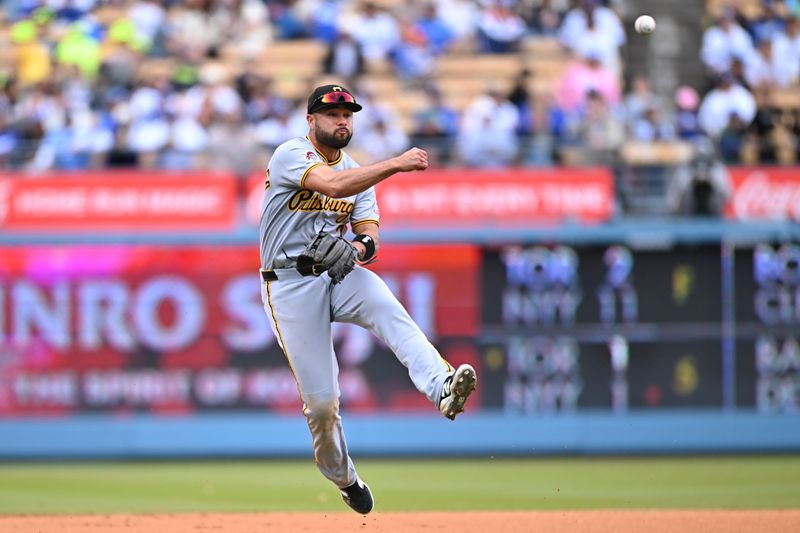 Apr 27, 2025; Los Angeles, California, USA; Pittsburgh Pirates shortstop Isiah Kiner-Falefa (7) throws to first base against the Los Angeles Dodgers during the eighth inning at Dodger Stadium. Mandatory Credit: Jonathan Hui-Imagn Images