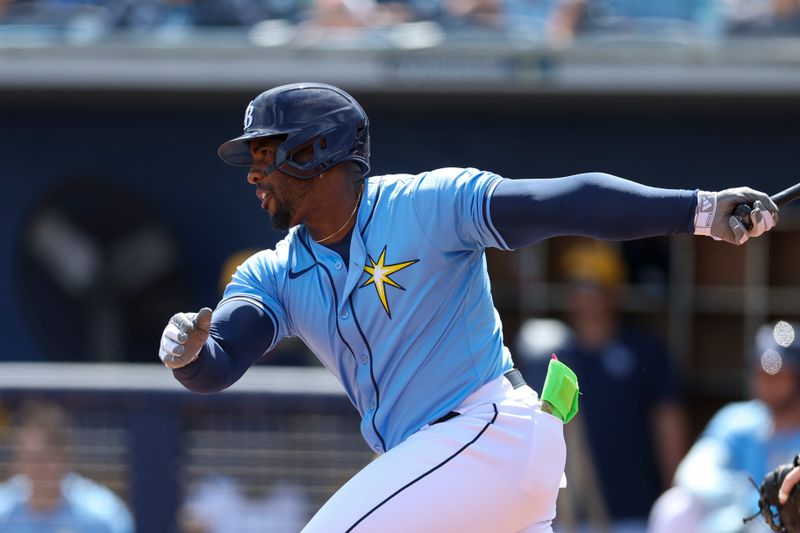 Mar 11, 2024; Port Charlotte, Florida, USA;  Tampa Bay Rays first baseman Yandy Diaz (2) hits a base hit against the Toronto Blue Jays in the first inning at Charlotte Sports Park. Mandatory Credit: Nathan Ray Seebeck-USA TODAY Sports