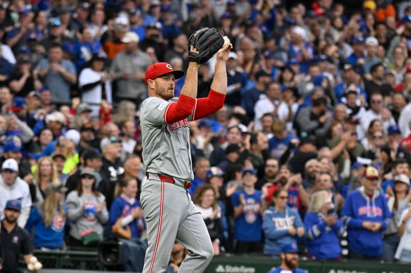 Sep 28, 2024; Chicago, Illinois, USA;  Cincinnati Reds pitcher Justin Wilson (32) reacts after Chicago Cubs third baseman Isaac Paredes (17) hits an RBI single during the eighth inning at Wrigley Field. Mandatory Credit: Matt Marton-Imagn Images