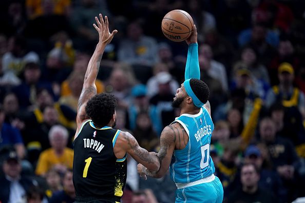 INDIANAPOLIS, INDIANA - DECEMBER 20: Miles Bridges #0 of the Charlotte Hornets shoots against Obi Toppin #1 of the Indiana Pacers in the first quarter at Gainbridge Fieldhouse on December 20, 2023 in Indianapolis, Indiana. NOTE TO USER: User expressly acknowledges and agrees that, by downloading and or using this photograph, User is consenting to the terms and conditions of the Getty Images License Agreement. (Photo by Dylan Buell/Getty Images)