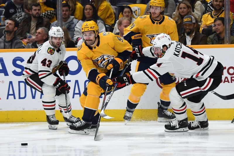 Jan 2, 2024; Nashville, Tennessee, USA; Nashville Predators left wing Filip Forsberg (9) skates with the puck against Chicago Blackhawks left winger Boris Katchouk (14) during the third period at Bridgestone Arena. Mandatory Credit: Christopher Hanewinckel-USA TODAY Sports