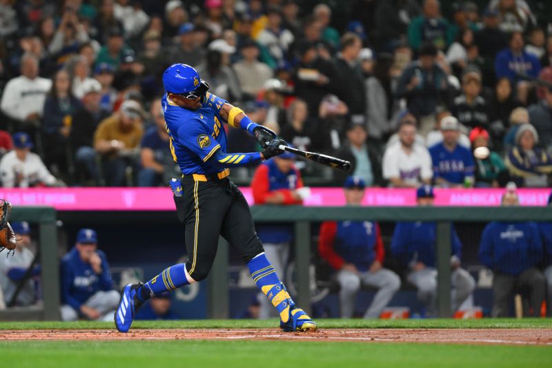 Sep 14, 2024; Seattle, Washington, USA; Seattle Mariners center fielder Julio Rodriguez (44) hits a single against the Texas Rangers during the first inning at T-Mobile Park. Mandatory Credit: Steven Bisig-Imagn Images