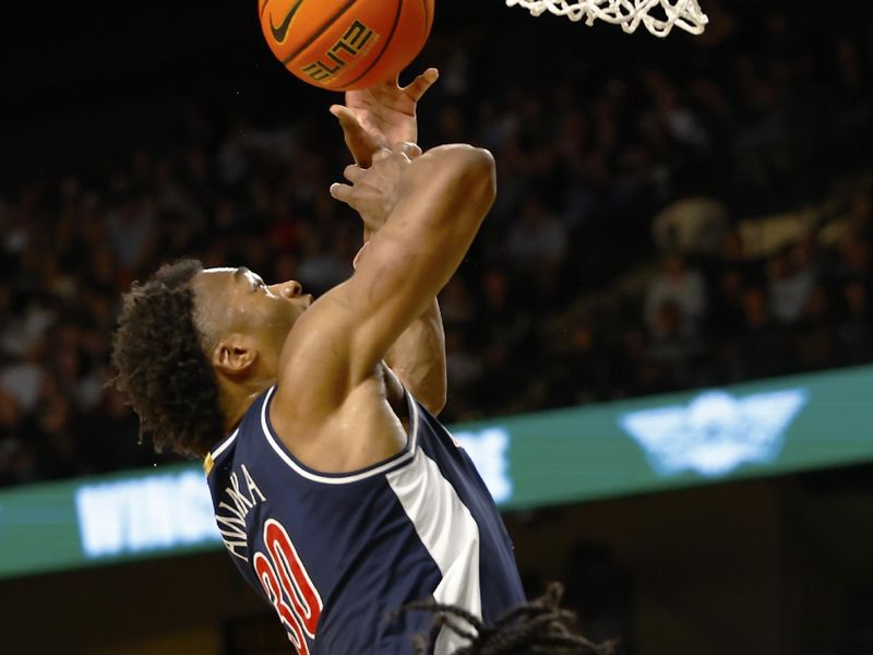 Jan 17, 2026; Orlando, Florida, USA;  Arizona Wildcats forward Tobe Awaka (30) is fouled by Central Florida Knights guard Themus Fulks (1) on a shot attempt in the second half at Addition Financial Arena. Mandatory Credit: Russell Lansford-Imagn Images