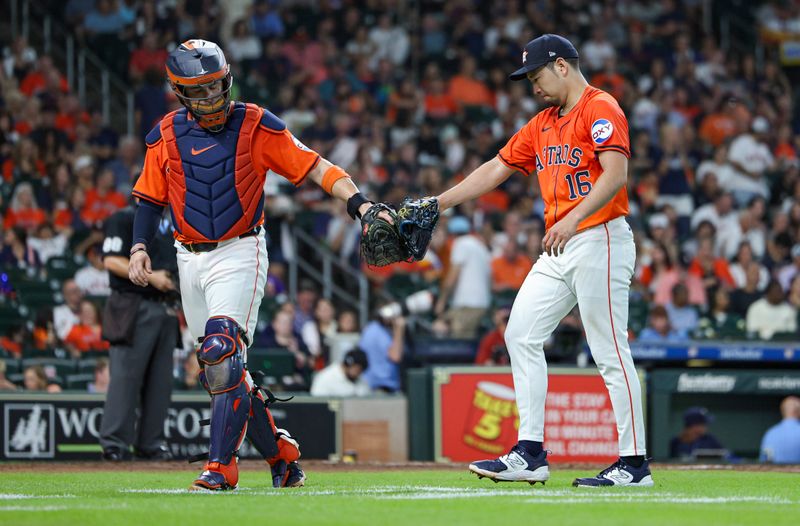 Aug 2, 2024; Houston, Texas, USA; Houston Astros starting pitcher Yusei Kikuchi (16) and catcher Victor Caratini (17) walk off the mound after the third inning against the Tampa Bay Rays at Minute Maid Park. Mandatory Credit: Troy Taormina-USA TODAY Sports