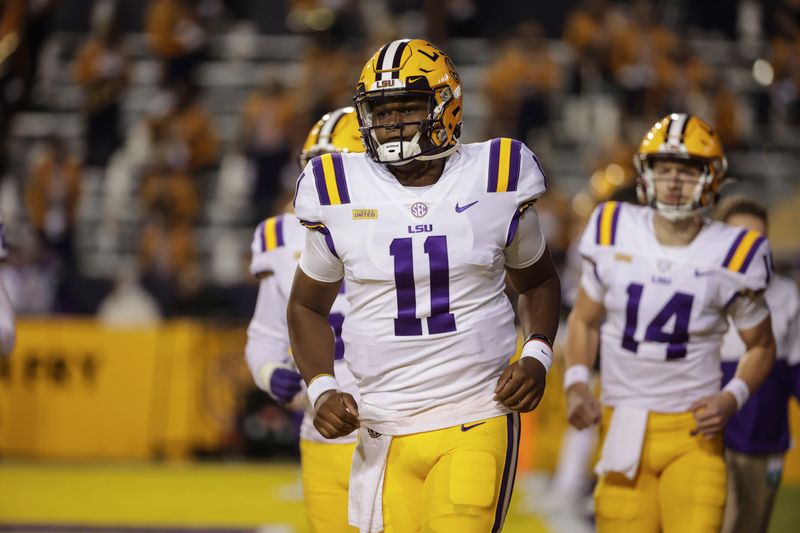 Dec 5, 2020; Baton Rouge, Louisiana, USA; LSU Tigers quarterback TJ Finley (11) runs onto the field prior to kickoff against the Alabama Crimson Tide at Tiger Stadium. Mandatory Credit: Derick E. Hingle-USA TODAY Sports