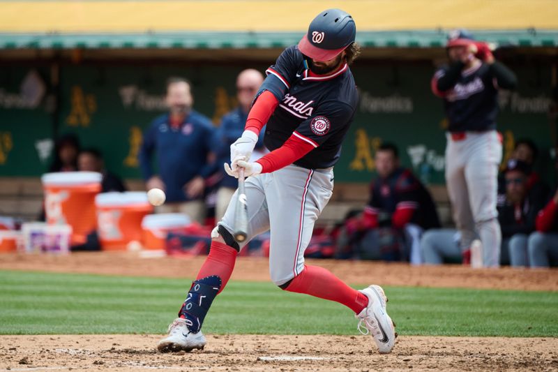 Apr 14, 2024; Oakland, California, USA; Washington Nationals outfielder Jesse Winker (6) hits a single against the Oakland Athletics  during the sixth inning at Oakland-Alameda County Coliseum. Mandatory Credit: Robert Edwards-USA TODAY Sports