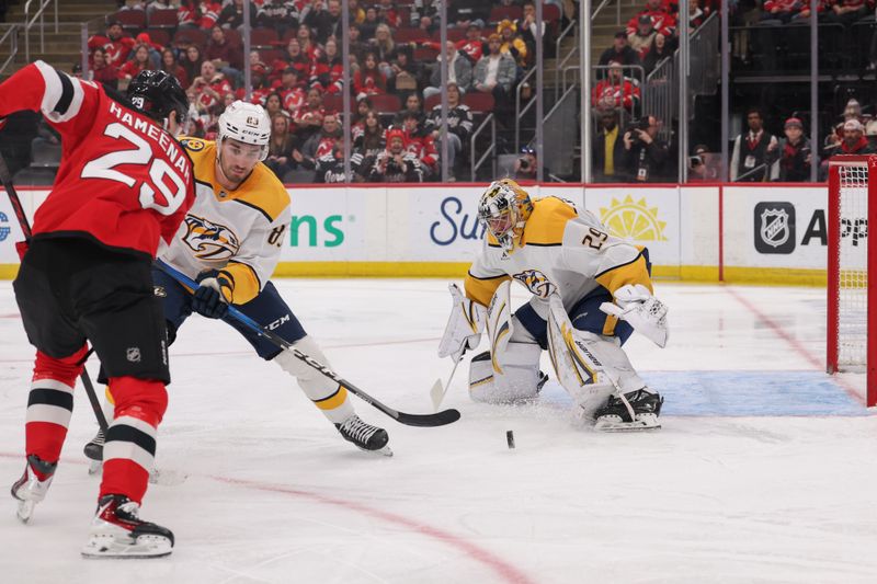 Jan 29, 2026; Newark, New Jersey, USA; Nashville Predators goaltender Justus Annunen (29) makes a save on New Jersey Devils right wing Lenni Hameenaho (29) during the second period at Prudential Center. Mandatory Credit: Ed Mulholland-Imagn Images