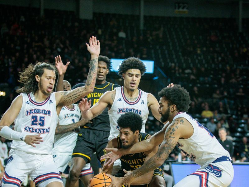 Feb 11, 2024; Wichita, Kansas, USA; Wichita State Shockers guard Harlond Beverly (20) attempts to keep control of the ball under the basket during the first half against the Florida Atlantic Owls at Charles Koch Arena. Mandatory Credit: William Purnell-USA TODAY Sports