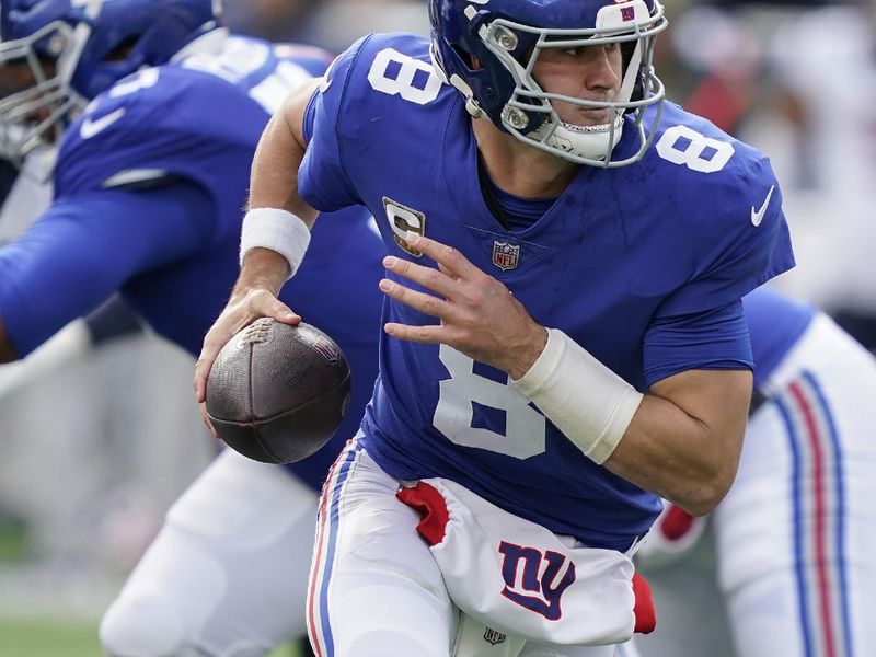 New York Giants quarterback Daniel Jones (8) rolls out of the pocket to pass against the Houston Texans during the second quarter of an NFL football game, Sunday, Nov. 13, 2022, in East Rutherford, N.J. (AP Photo/John Minchillo)