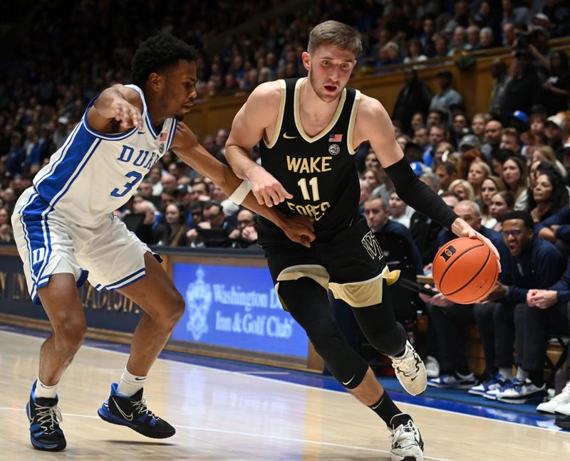 Feb 12, 2024; Durham, North Carolina, USA;  Wake Forest Deamon Deacons forward Andrew Carr (11) drives to the basket as Duke Blue Devils forward Sean Stewart (13) defends during the first half at Cameron Indoor Stadium. Mandatory Credit: Rob Kinnan-USA TODAY Sports