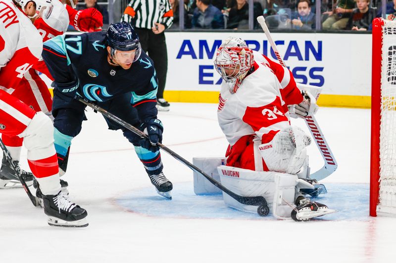 Feb 19, 2024; Seattle, Washington, USA; Detroit Red Wings goaltender Alex Lyon (34) blocks a the puck on a shot by Seattle Kraken center Jaden Schwartz (17) during the second period at Climate Pledge Arena. Mandatory Credit: Joe Nicholson-USA TODAY Sports