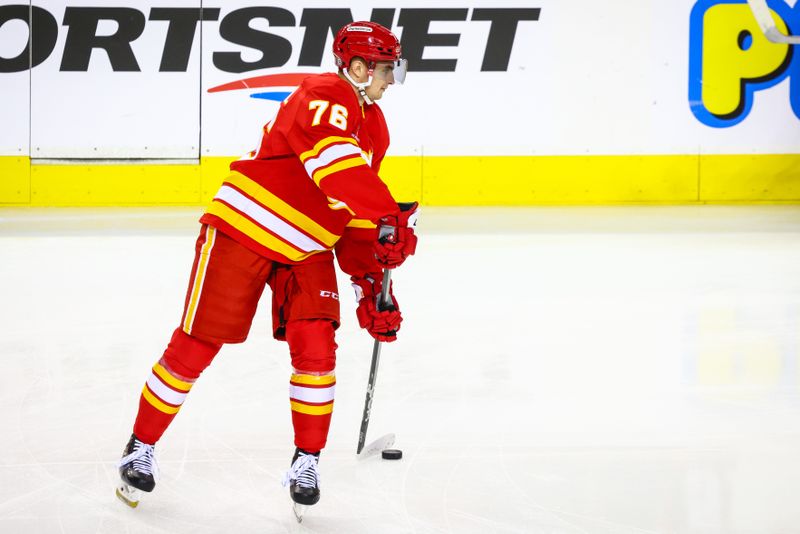 Oct 4, 2024; Calgary, Alberta, CAN; Calgary Flames center Martin Pospisil (76) controls the puck during the warmup period against the Winnipeg Jets at Scotiabank Saddledome. Mandatory Credit: Sergei Belski-Imagn Images