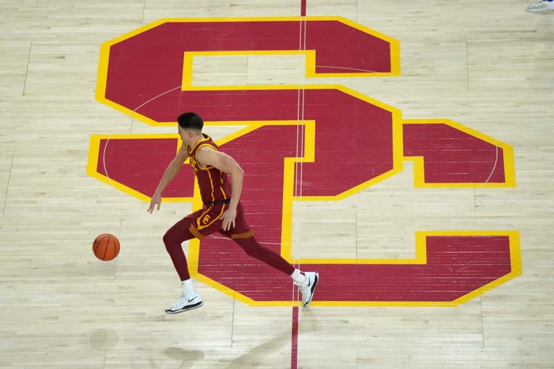 Jan 27, 2025; Los Angeles, California, USA; Southern California Trojans forward Josh Cohen (33) dribbles the ball across the SC logo at midcourt against the UCLA Bruins in the first half at Galen Center. Mandatory Credit: Kirby Lee-Imagn Images